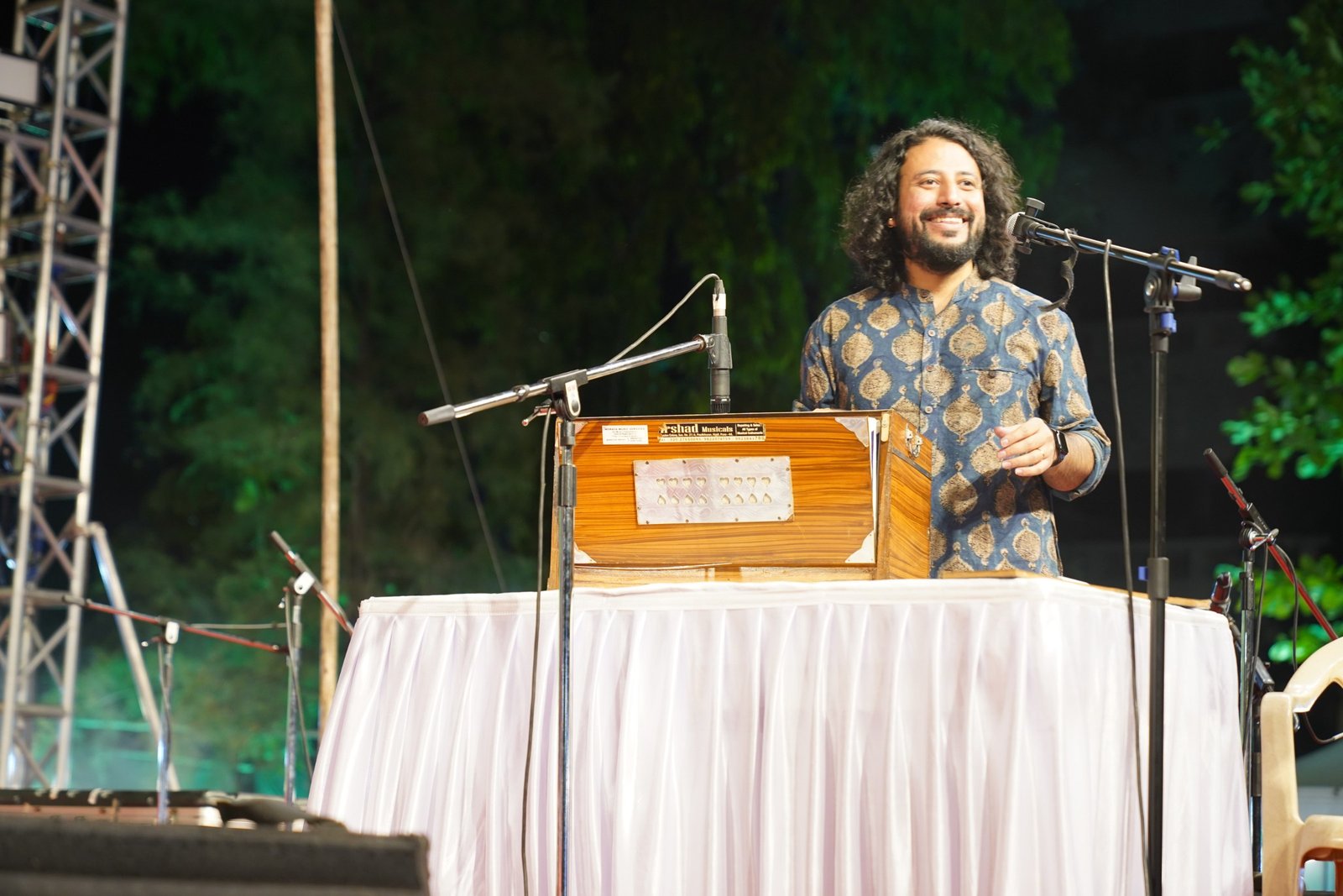 Saurabh Zadoo at the harmonium on a cloth-covered stage table
