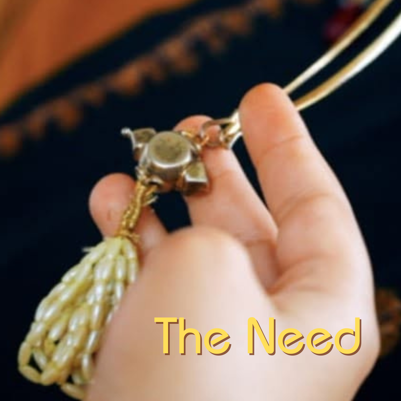 The Need — a hand holding a Kashmiri dejhoor